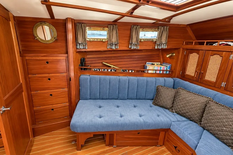 Slide: The Image of Interior of 1988 Gozzard Cutter 36 with wooden cabinetry and blue seating. - 21