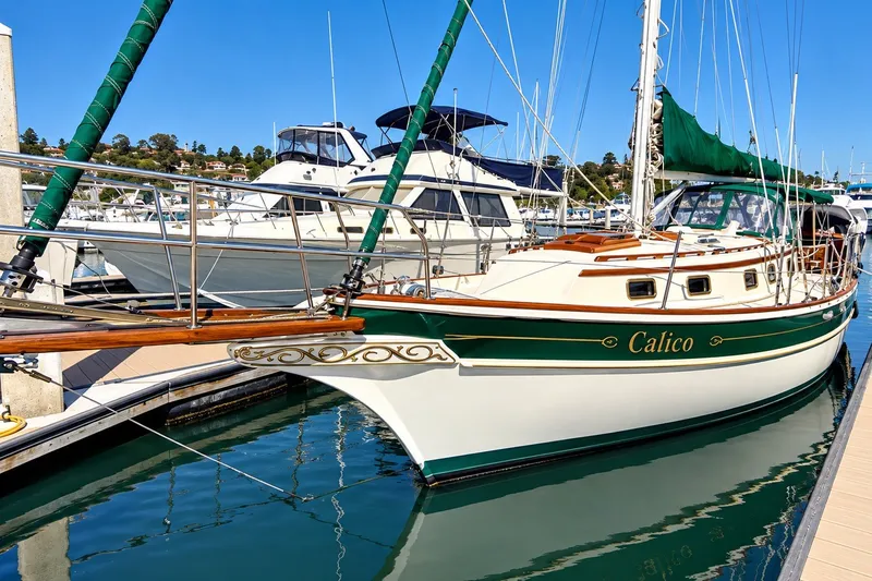Slide: The Image of 1988 Gozzard Cutter 36 sailboat named "Calico" docked in a marina. - 4
