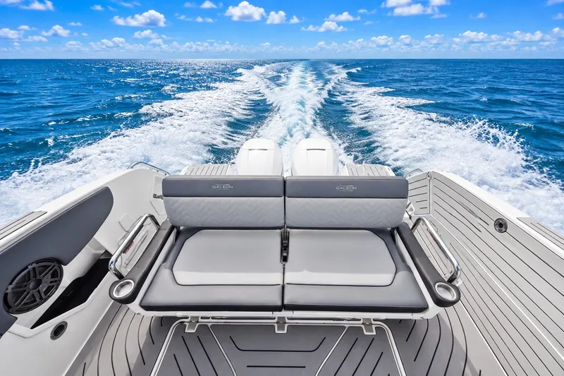 Slide: The Image of 2023 Galeon 325 GTO boat cruising on open sea with wake trail. - 2