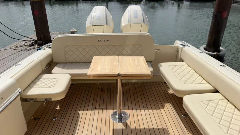 Slide: The Image of The image shows the cockpit of a Chris-Craft Calypso 30 boat with beige seating and a wooden table. - 17