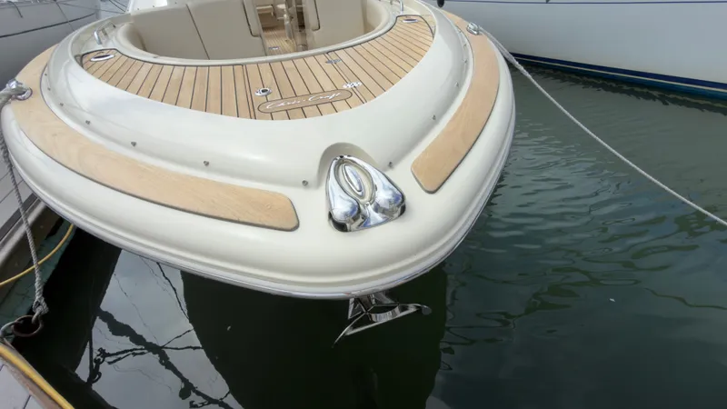 Slide: The Image of The 2022 Chris-Craft Calypso 30 features elegant design with wood decking and an anchor. - 9