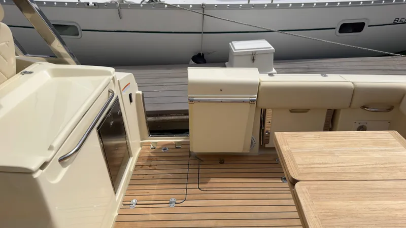 Slide: The Image of The image shows the deck of a 2022 Chris-Craft Calypso 30 with wooden flooring and seating area. - 2