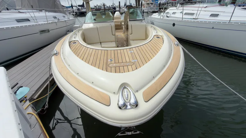 Slide: The Image of The 2022 Chris-Craft Calypso 30 is docked, featuring a sleek wooden deck. - 10