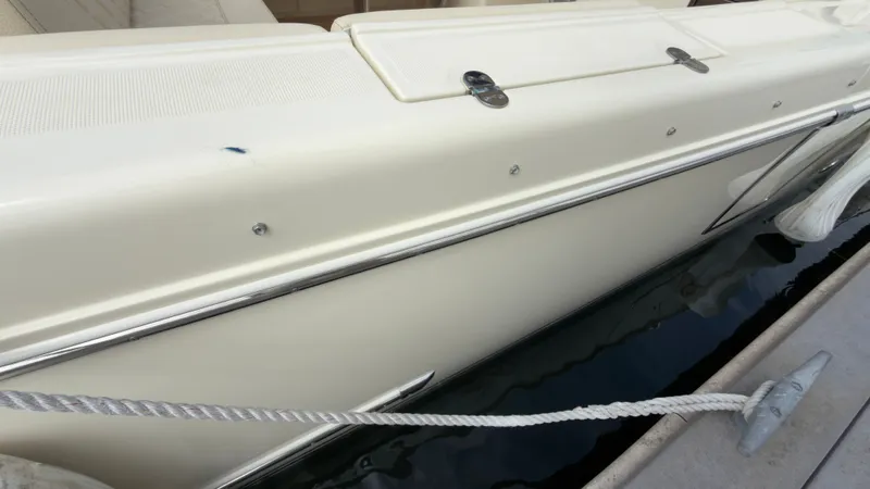 Slide: The Image of The 2022 Chris-Craft Calypso 30 is docked. Visible are the white hull and fittings. - 20