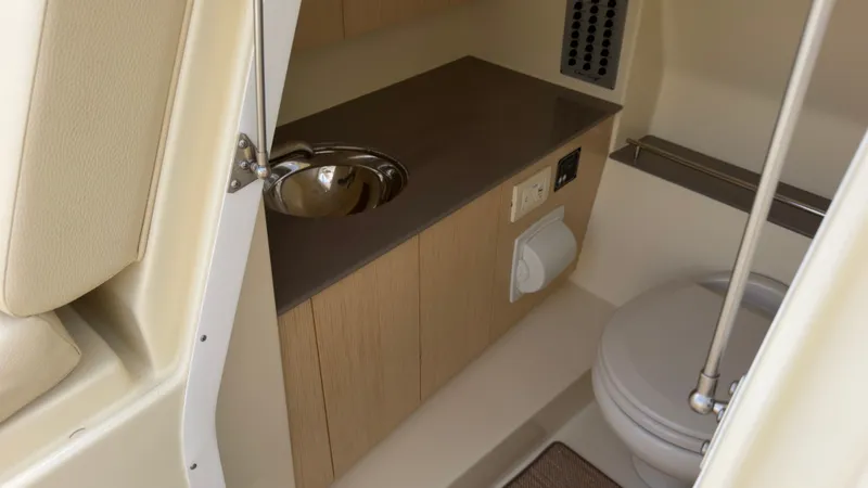 Slide: The Image of Interior of a 2022 Chris-Craft Calypso 30 featuring a sink and toilet. - 14