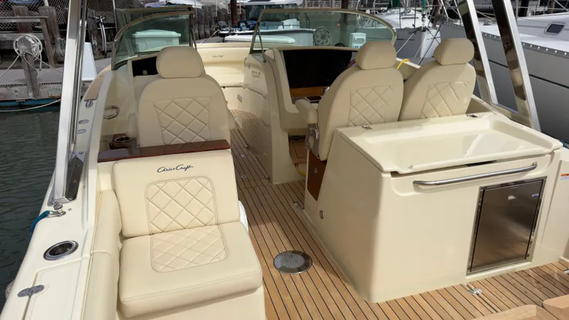 Slide: The Image of The image shows the cockpit of a 2022 Chris-Craft Calypso 30 boat with elegant seating. - 1