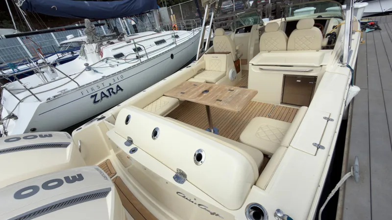 Slide: The Image of A 2022 Chris-Craft Calypso 30 docked. It features a spacious, elegant seating area. - 7