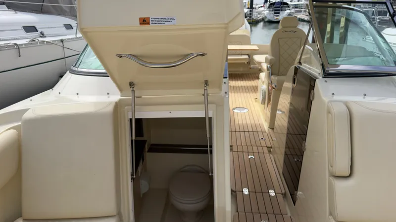 Slide: The Image of The image shows the interior of a 2022 Chris-Craft Calypso 30 with an open toilet area. - 15