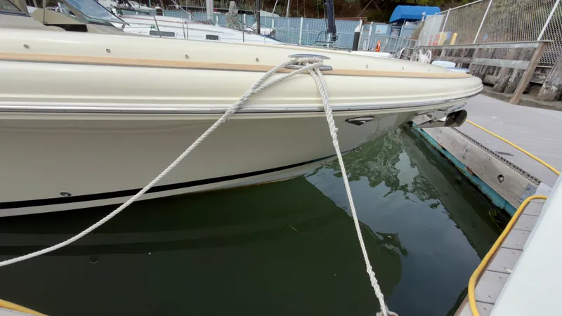 Slide: The Image of A 2022 Chris-Craft Calypso 30 docked. The boat is cream-colored with a sleek design. - 23