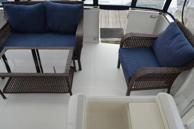 Slide: The Image of Outdoor seating area on a 2000 Carver 356 Aft Cabin Motor Yacht with wicker furniture. - 17