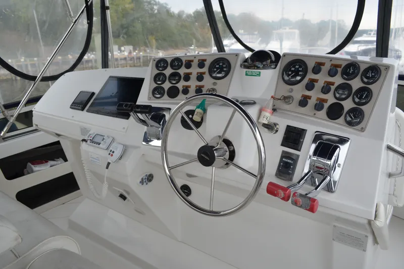Slide: The Image of Control panel of a 2000 Carver 356 Aft Cabin Motor Yacht with steering wheel and gauges. - 22