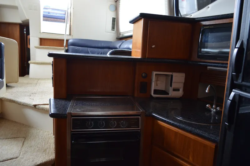 Slide: The Image of Interior of 2000 Carver 356 Aft Cabin Motor Yacht with kitchen and seating area. - 35