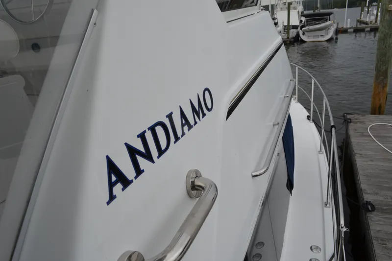 Slide: The Image of 2000 Carver 356 Aft Cabin Motor Yacht docked, featuring "Andiamo" name on the side. - 6