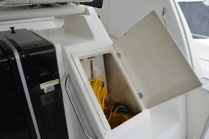 Slide: The Image of Open storage compartment on 2000 Carver 356 Aft Cabin Motor Yacht with yellow rope inside. - 19