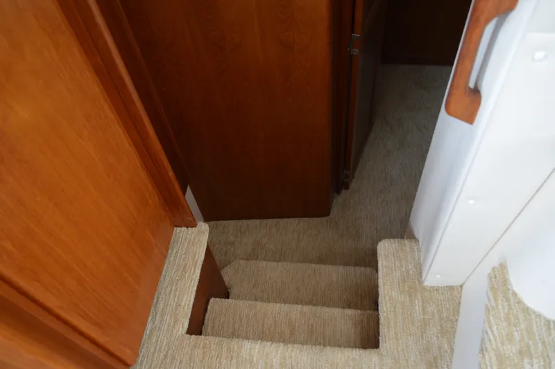 Slide: The Image of Carpeted stairs inside 2000 Carver 356 Aft Cabin Motor Yacht, featuring wooden paneling. - 45
