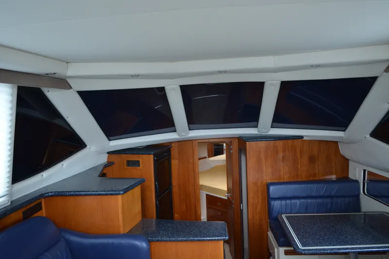 Slide: The Image of Interior of 2000 Carver 356 Aft Cabin Motor Yacht with wood and blue upholstery. - 27