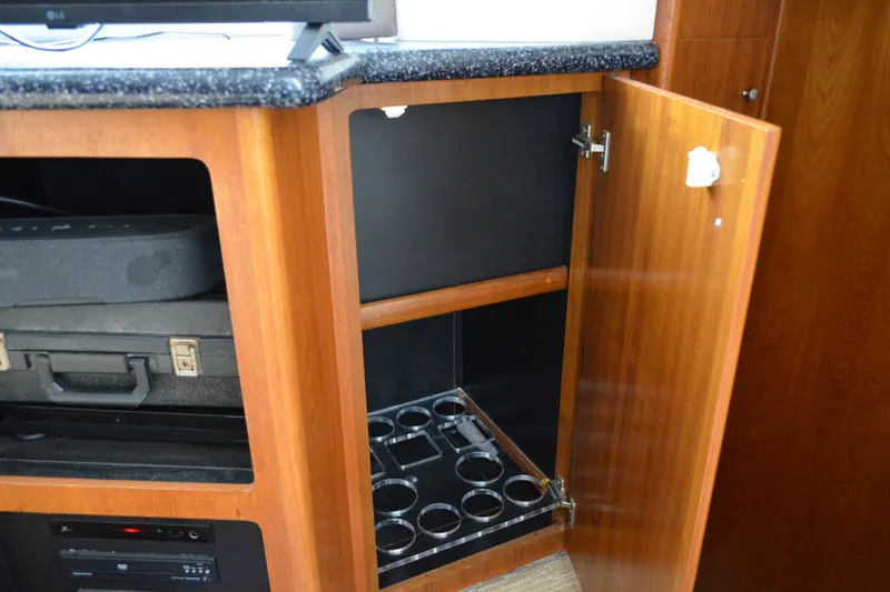 Slide: The Image of Open cabinet in 2000 Carver 356 Aft Cabin Motor Yacht with storage and electronics. - 46