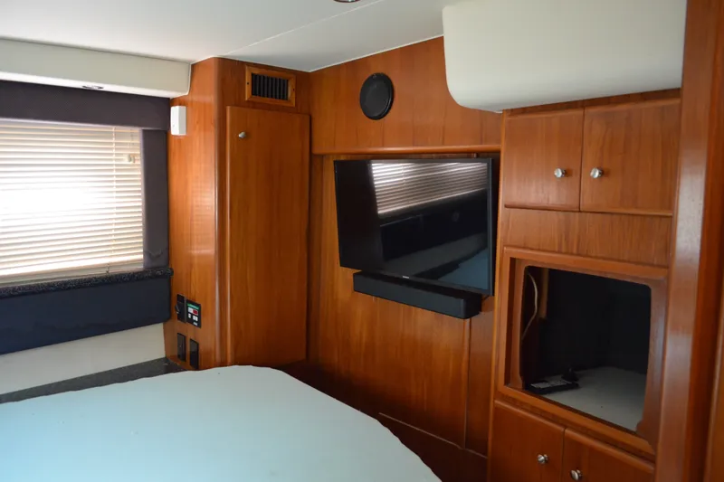 Slide: The Image of Interior of 2000 Carver 356 Aft Cabin Motor Yacht with wood paneling and TV. - 50