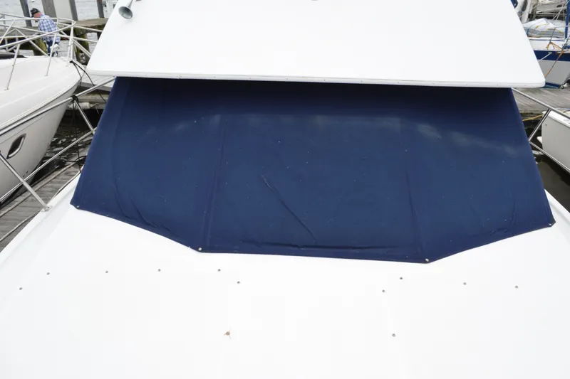 Slide: The Image of 2000 Carver 356 Aft Cabin Motor Yacht with blue canvas cover at dock. - 9