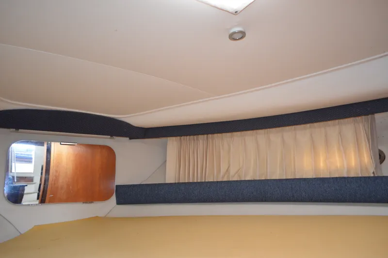 Slide: The Image of Interior of 2000 Carver 356 Aft Cabin Motor Yacht with curtains and wooden door. - 44