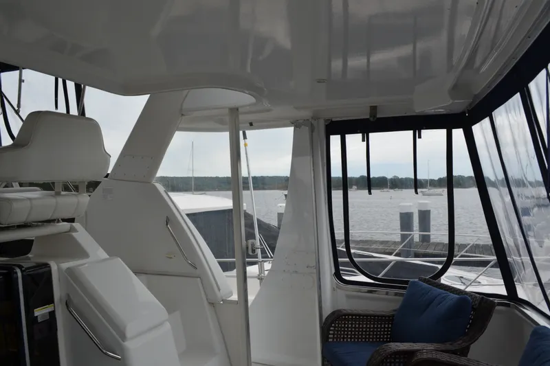 Slide: The Image of Interior view of 2000 Carver 356 Aft Cabin Motor Yacht with seating and water view. - 12