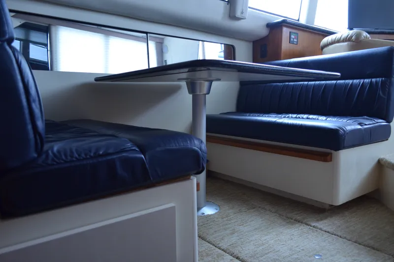 Slide: The Image of Interior of 2000 Carver 356 Aft Cabin Motor Yacht with blue leather seating. - 32