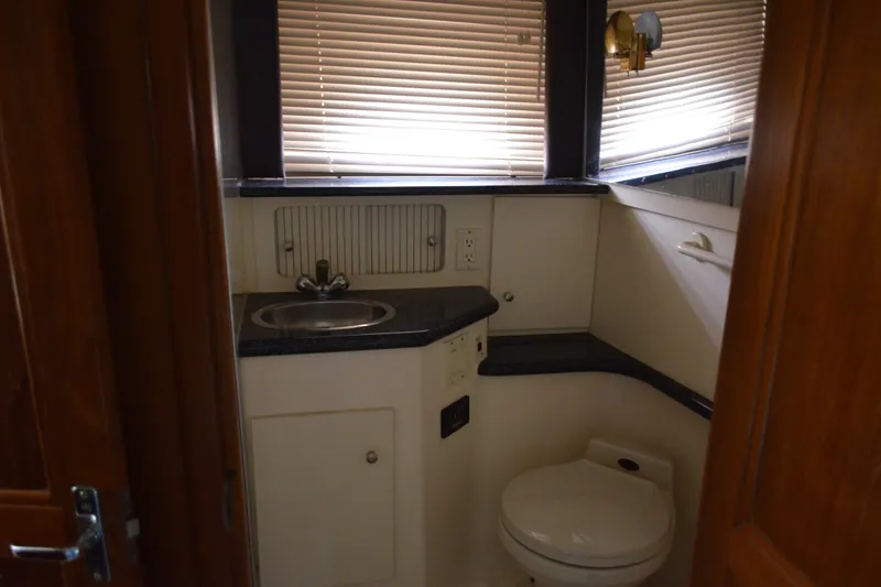 Slide: The Image of Bathroom interior of 2000 Carver 356 Aft Cabin Motor Yacht with sink and toilet. - 52