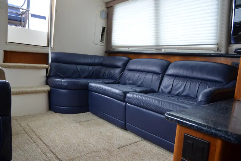 Slide: The Image of Interior of 2000 Carver 356 Aft Cabin Motor Yacht with blue leather seating. - 28