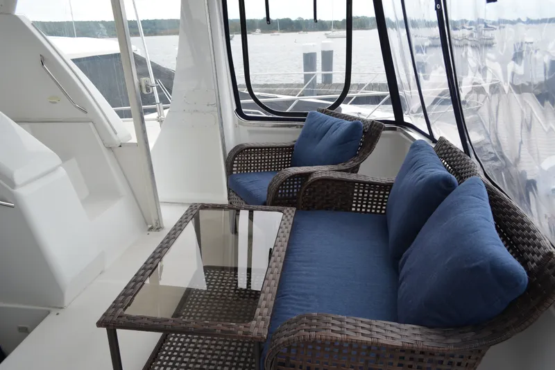 Slide: The Image of Carver 356 Aft Cabin Motor Yacht 2000 interior with wicker seating and blue cushions. - 11