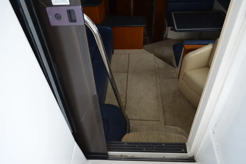Slide: The Image of Interior view of 2000 Carver 356 Aft Cabin Motor Yacht, featuring seating and table. - 25