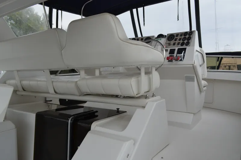 Slide: The Image of Interior helm of 2000 Carver 356 Aft Cabin Motor Yacht with white seating and control panel. - 18