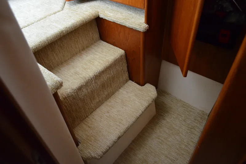 Slide: The Image of Carpeted stairs inside a 2000 Carver 356 Aft Cabin Motor Yacht. - 48