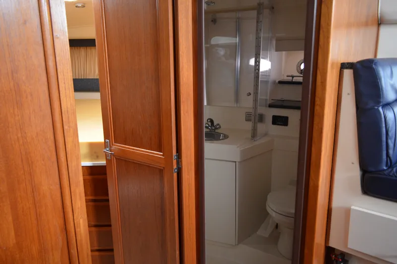 Slide: The Image of Interior of 2000 Carver 356 Aft Cabin Motor Yacht, featuring bathroom and wooden cabinetry. - 37