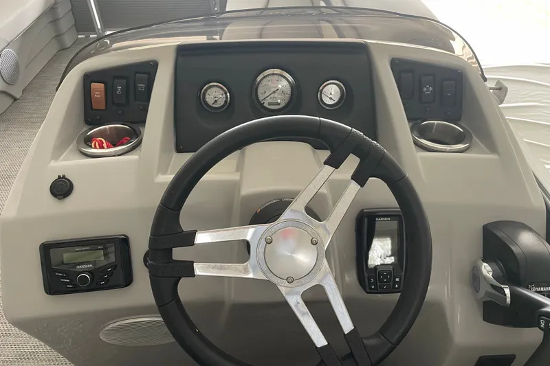 Slide: The Image of 2023 Bennington 20 SS boat dashboard with steering wheel and control panel. - 14