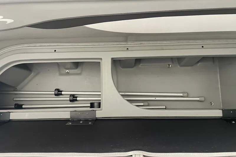 Slide: The Image of Storage compartment of 2023 Bennington 20 SS boat with metal rods inside. - 20