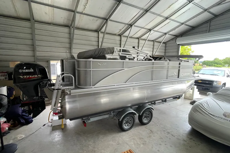 Slide: The Image of 2023 Bennington 20 SS pontoon boat in a garage with Yamaha VMAX engine. - 17