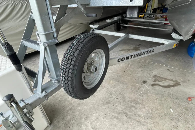 Slide: The Image of Trailer for 2023 Bennington 20 SS boat with Continental branding in a garage. - 18
