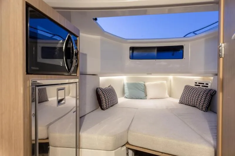 Slide: The Image of Interior of a 2026 Jeanneau Leader 10.5 CC with a cozy bed and microwave. - 20