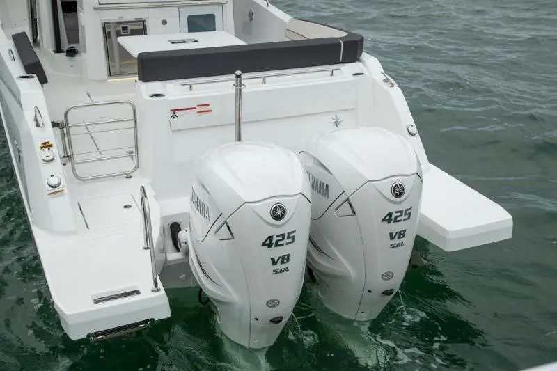Slide: The Image of The image shows the stern of a 2026 Jeanneau Leader 10.5 CC boat with twin Yamaha 425 V8 outboard engines. - 15