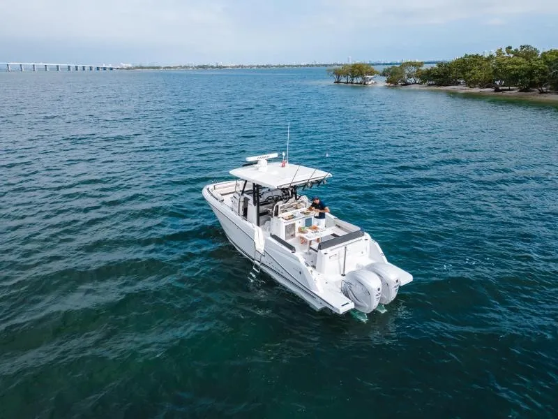 Slide: The Image of A modern motorboat cruises on calm waters, surrounded by green islands and a blue sky. - 14