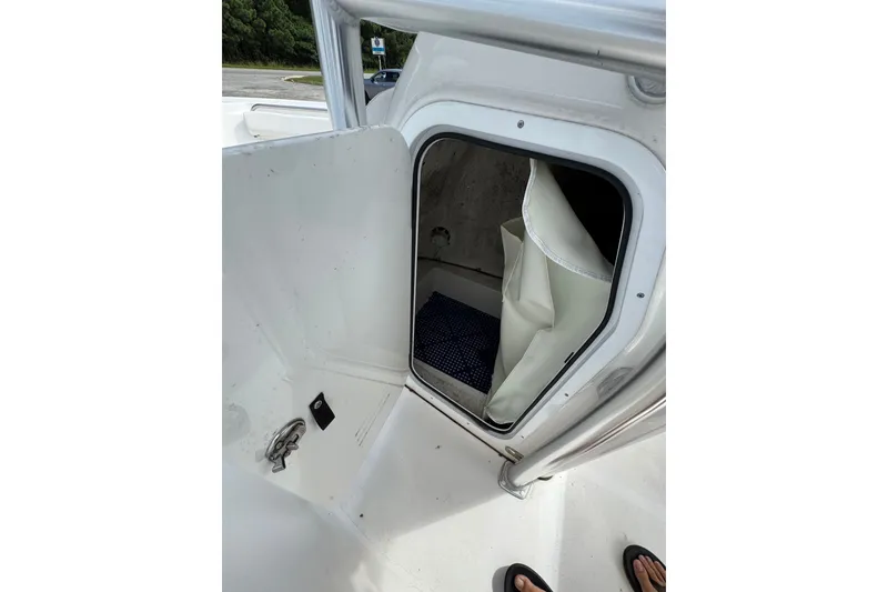 Slide: The Image of 2020 Tidewater 198 CC Adventure boat storage compartment with open door. - 4