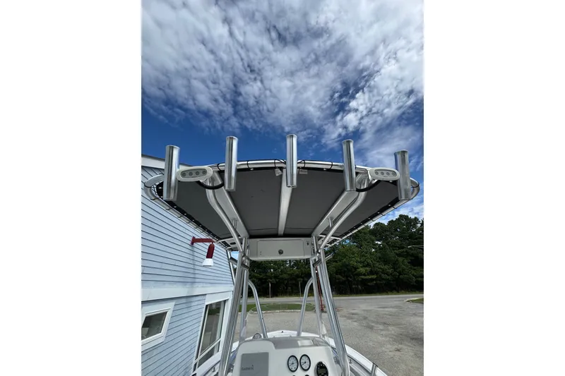 Slide: The Image of Tidewater 198 CC Adventure 2020 boat with T-top under a partly cloudy sky. - 6