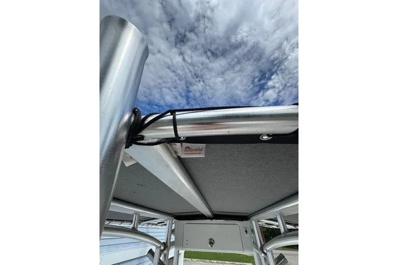 Slide: The Image of Tidewater 198 CC Adventure 2020 boat canopy with Sunbrella fabric under a cloudy sky. - 7