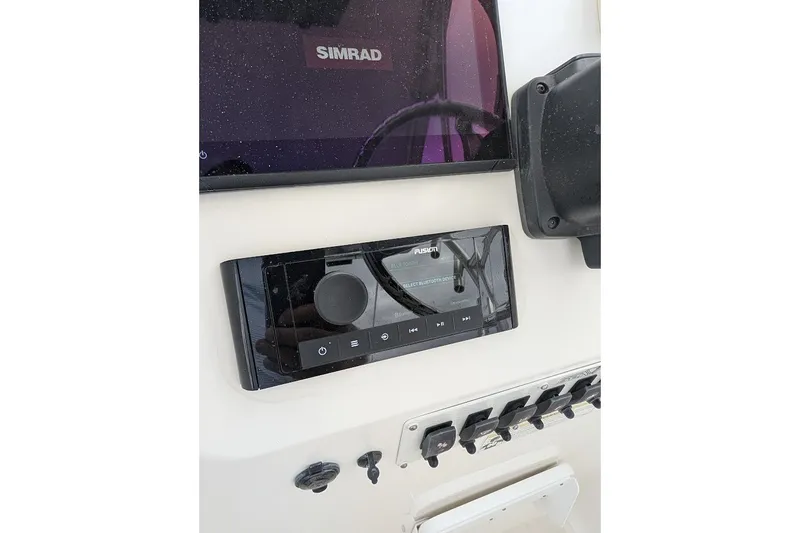 Slide: The Image of Control panel of a 2012 Sea Fox 216 Walk Around boat with Simrad and Fusion systems. - 13