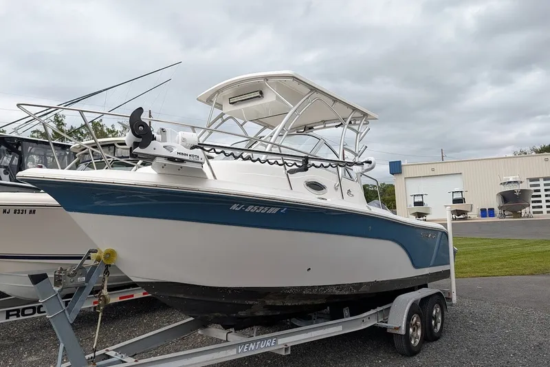 Slide: The Image of 2012 Sea Fox 216 Walk Around boat on trailer, parked outdoors near a building. - 21