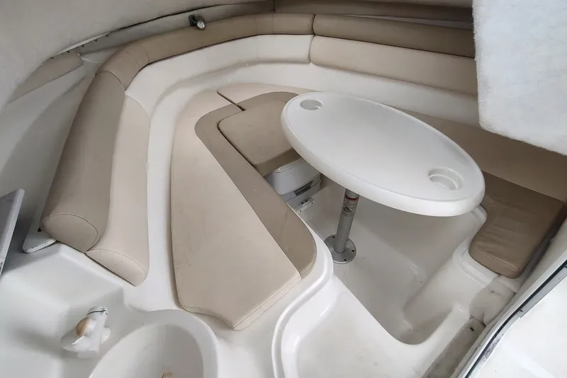Slide: The Image of 2012 Sea Fox 216 Walk Around cabin interior with beige seating and white table. - 18