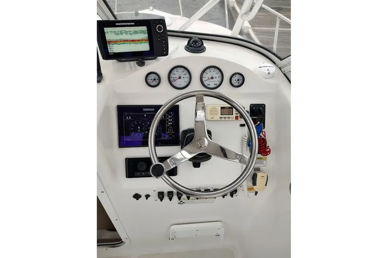 Slide: The Image of Helm of 2012 Sea Fox 216 Walk Around with navigation instruments and steering wheel. - 10