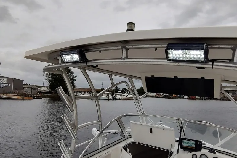 Slide: The Image of 2012 Sea Fox 216 Walk Around boat with LED lights on a cloudy day. - 16