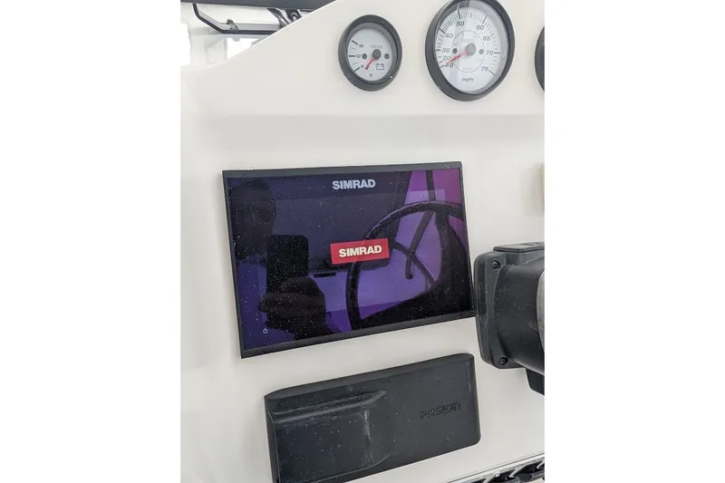 Slide: The Image of Dashboard of 2012 Sea Fox 216 Walk Around with Simrad display and gauges. - 12