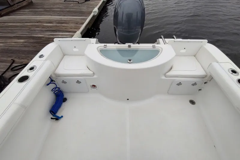 Slide: The Image of 2012 Sea Fox 216 Walk Around boat interior with seating and storage compartments. - 5